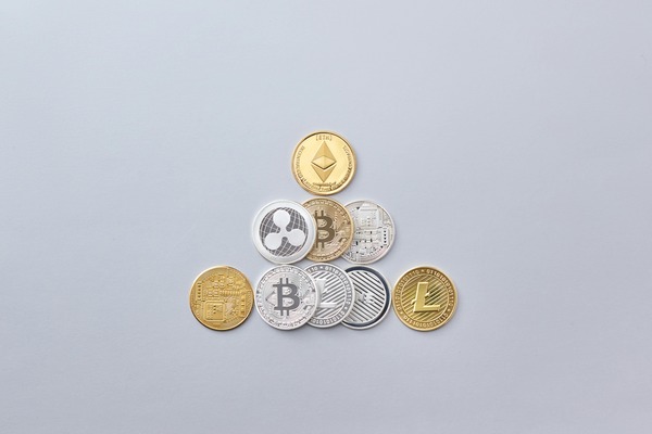 Crypto coins arranged in a triangle on a light surface