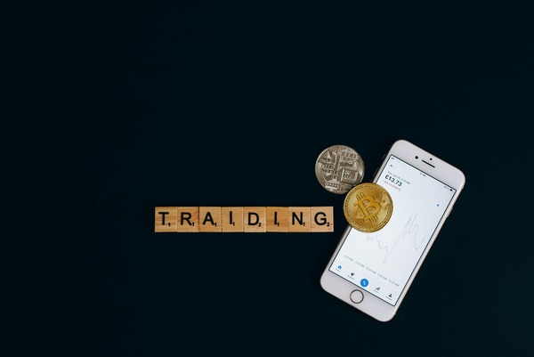 Trading letter tiles with coins and a phone