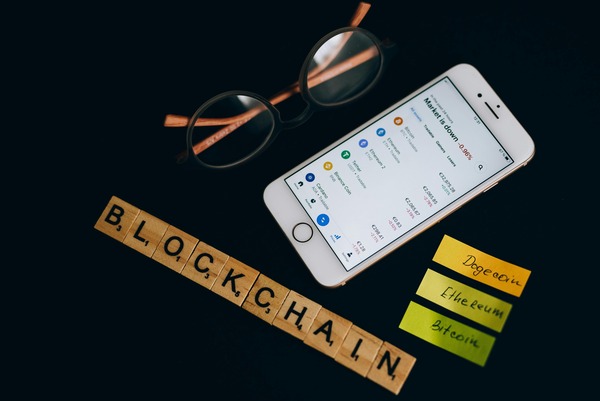 Phone with a wallet list, glasses and blockchain letter tiles