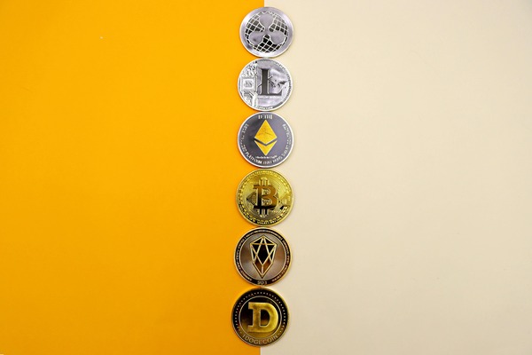 Column of crypto coins on a yellow and beige background