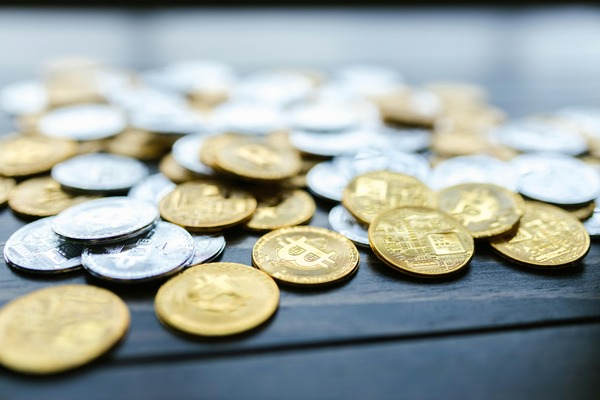 Gold and silver coins scattered on a dark table