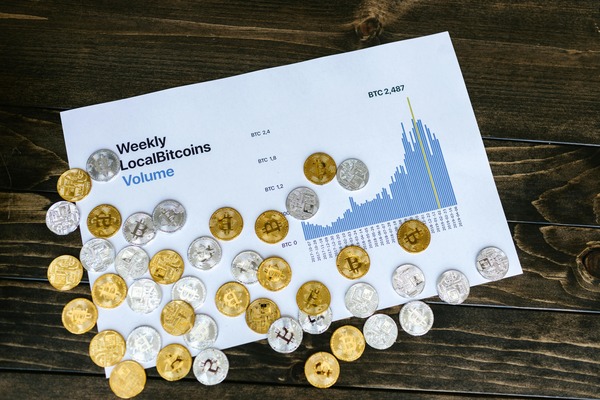 Coins spread over a printed volume chart