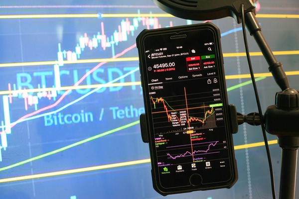 Phone on a tripod showing a trading chart