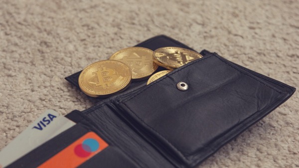 Gold coins lying on a leather wallet