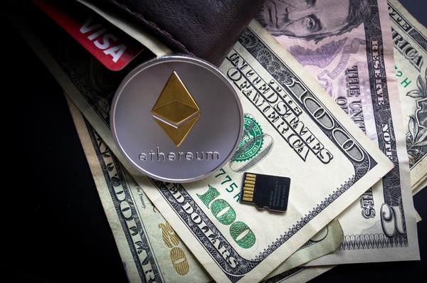 Ethereum coin on dollar bills with a memory card
