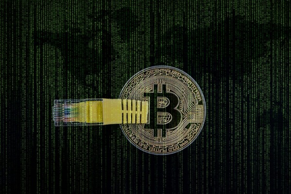 Bitcoin coin connected to a network cable